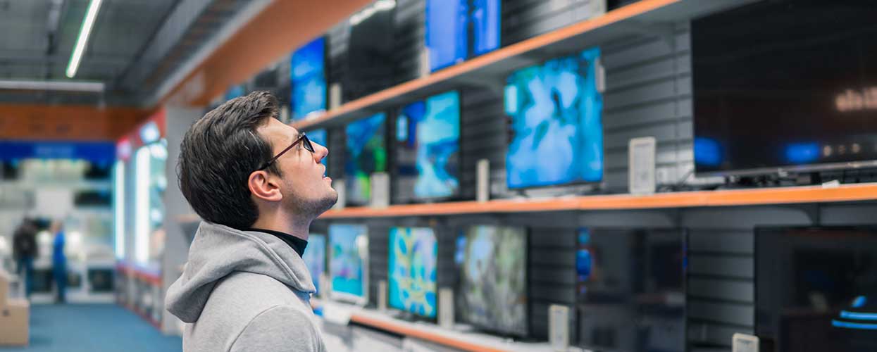 Customer looking at new tvs