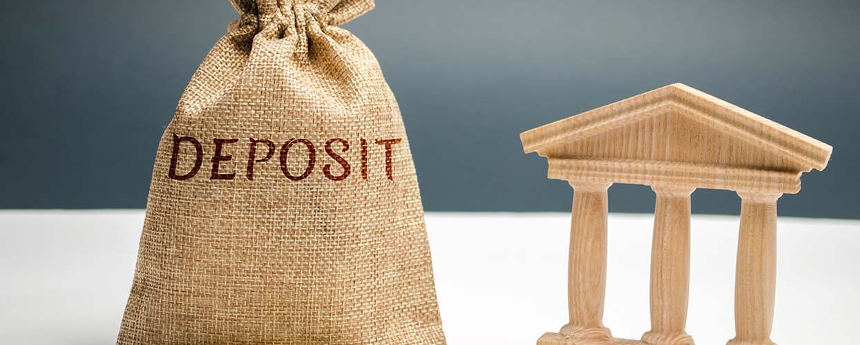 A money bag with the word, "Deposit" written on it"