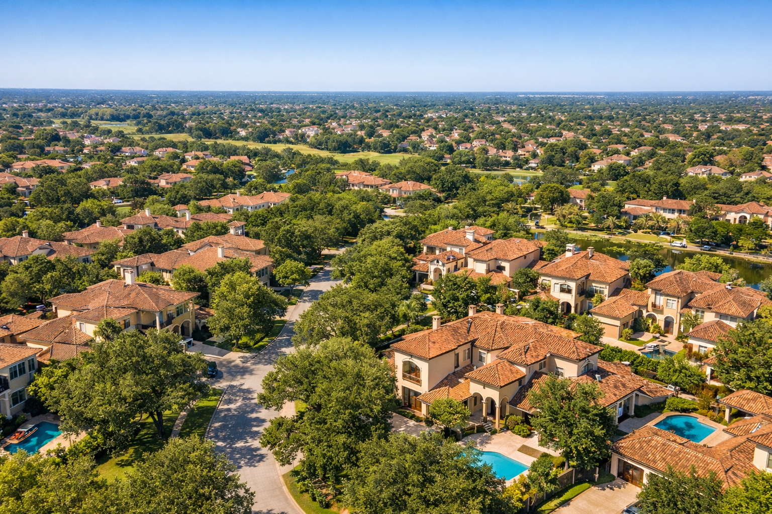 Aerial view of Mediterranean-style homes for sale in Cinco Ranch Southwest, TX, Katy, surrounded by oak-lined streets.