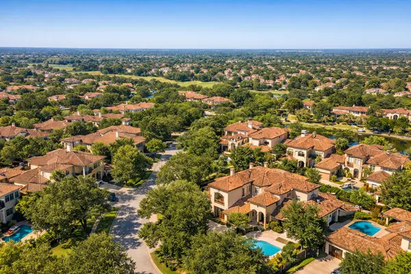 Aerial view of Mediterranean-style homes for sale in Cinco Ranch Southwest, TX, Katy, surrounded by oak-lined streets.