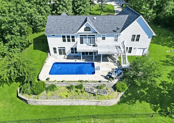 Luxury Lake of the Ozarks home with private pool, outdoor patio, and spacious backyard in a residential neighborhood