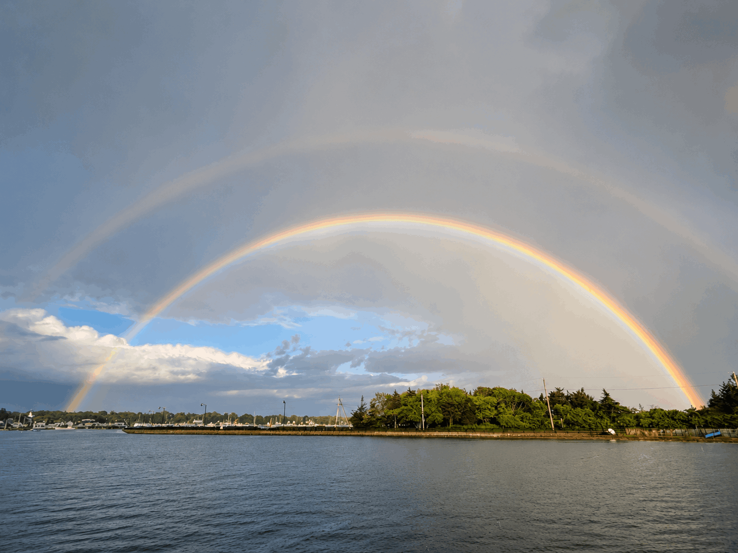 Double rainbow over the Padanaram Harbor mooring field and tree line