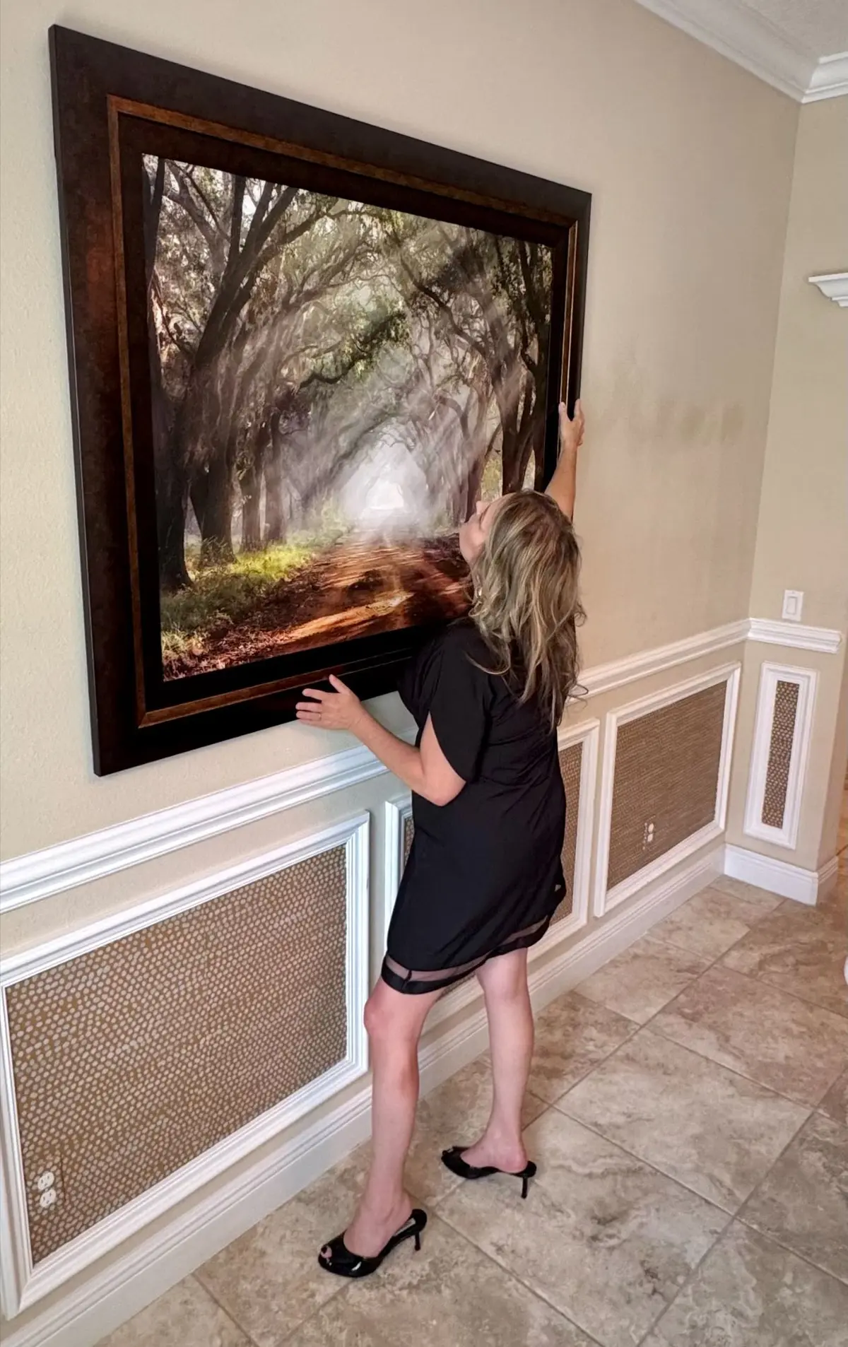 Adrienne Kane styling wall art during professional home staging to create a strong first impression
