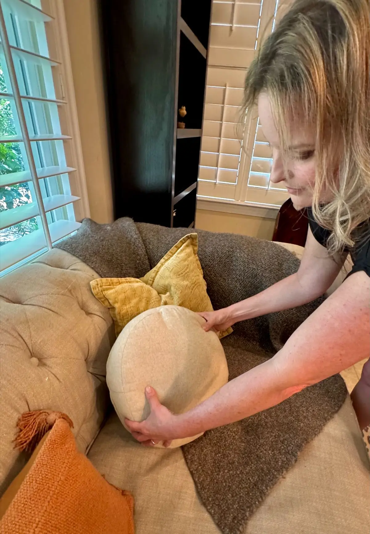 Adrienne Kane preparing a living room through professional home staging to help buyers emotionally connect