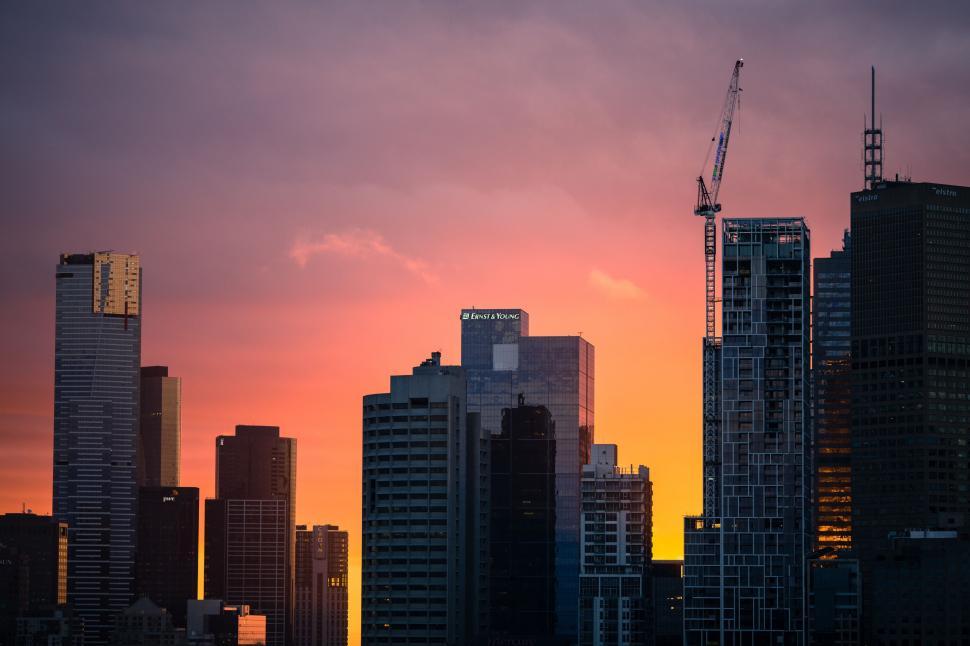 city-skyline-at-sunset-with-crane-in-background