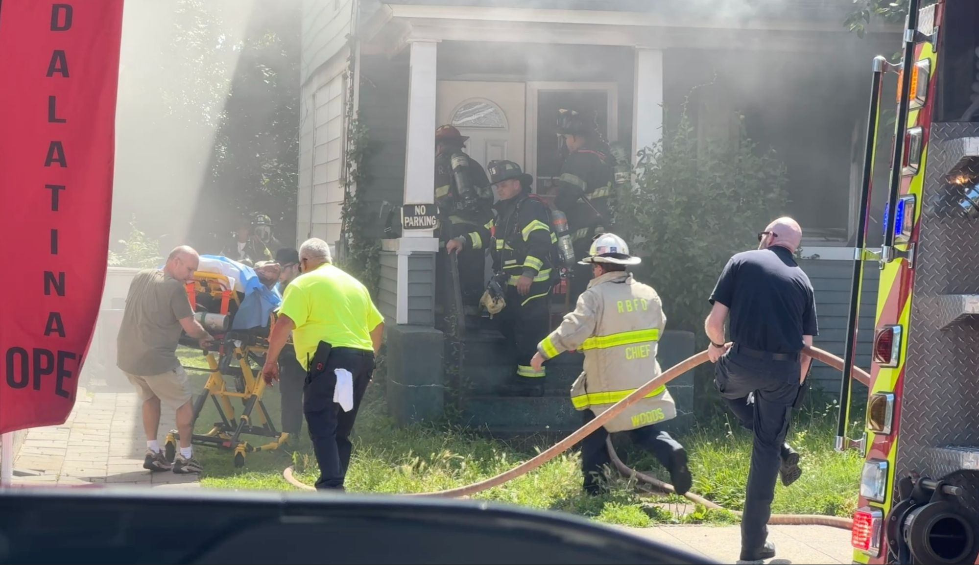 Emergency personnel saving a family from house fire 