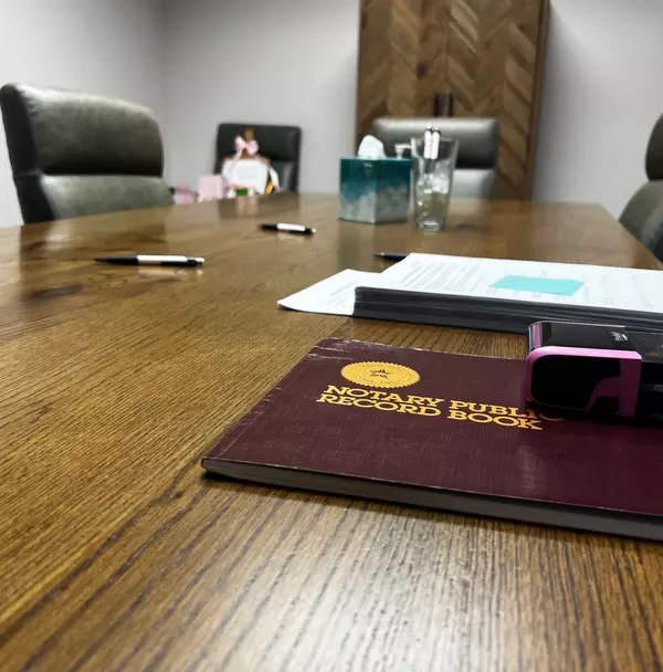 The closing Table ready to sign the never ending stack of documents to OWN you home