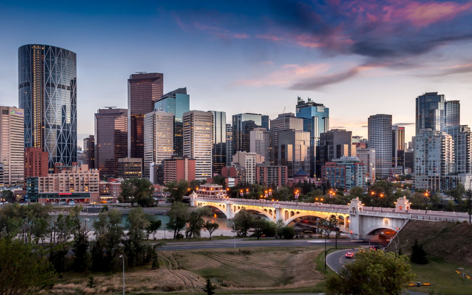 Calgary skyline at dusk with buildings and a river