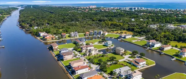 Aerial view of waterfront homes and boat docks on the canals of Yacht Harbor Village along the Intracoastal Waterway in Palm Coast FL