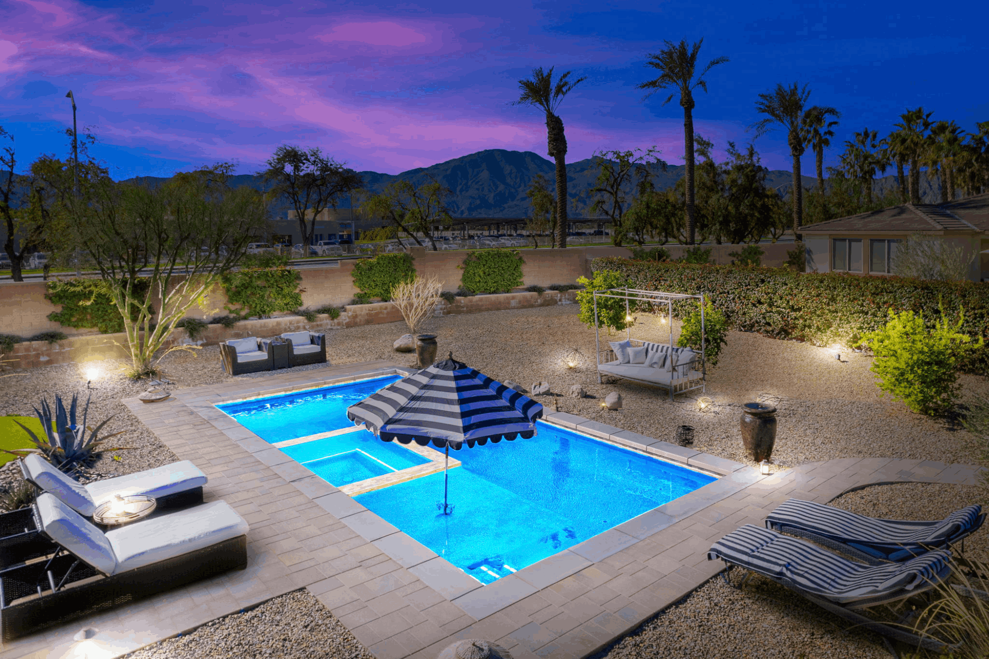 Trilogy at The Polo Club home in Indio with a private pool, desert landscaping and mountain views at twilight