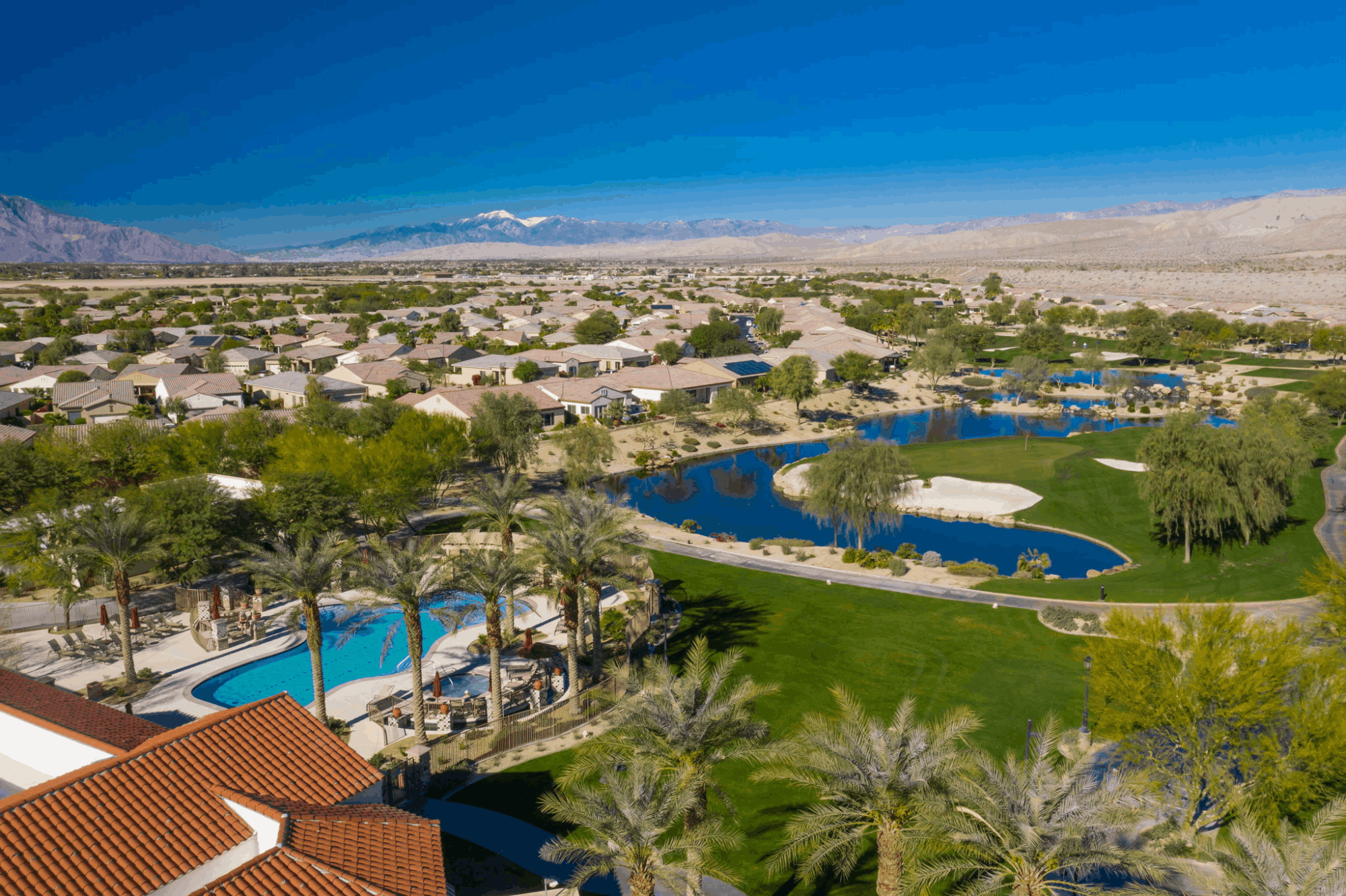 Sun City Shadow Hills swimming pool and golf course overlooking lakes, desert homes and surrounding mountains