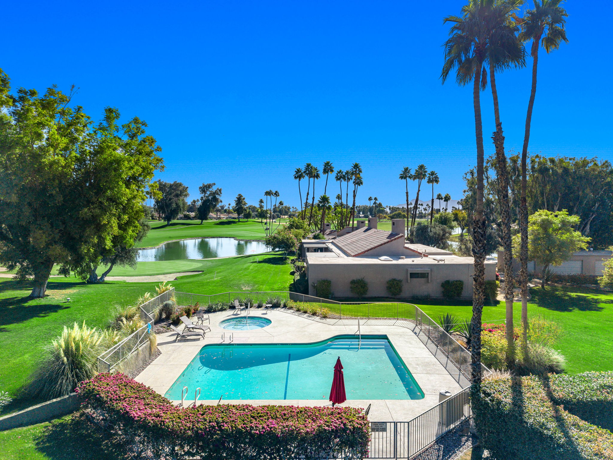 Swimming pool and spa overlooking the golf course and lake at Mission Hills Country Club in Rancho Mirage, California
