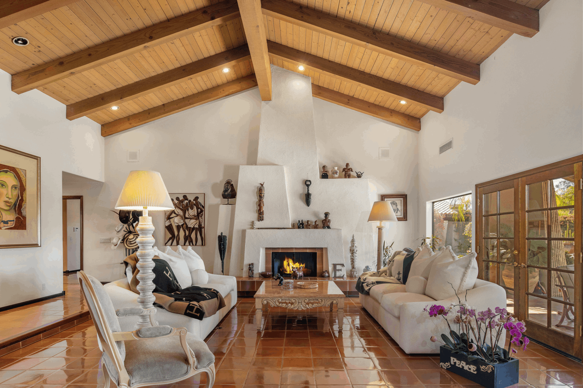 Bermuda Dunes Country Club residence featuring a vaulted wood-beam ceiling, fireplace, terracotta tile floors and French doors
