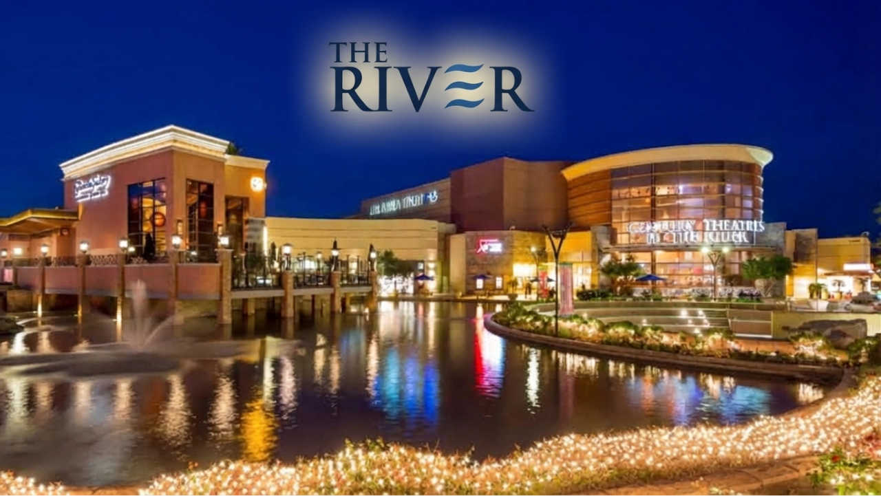 The River at Rancho Mirage illuminated at night with restaurants, shops and waterfront reflections.