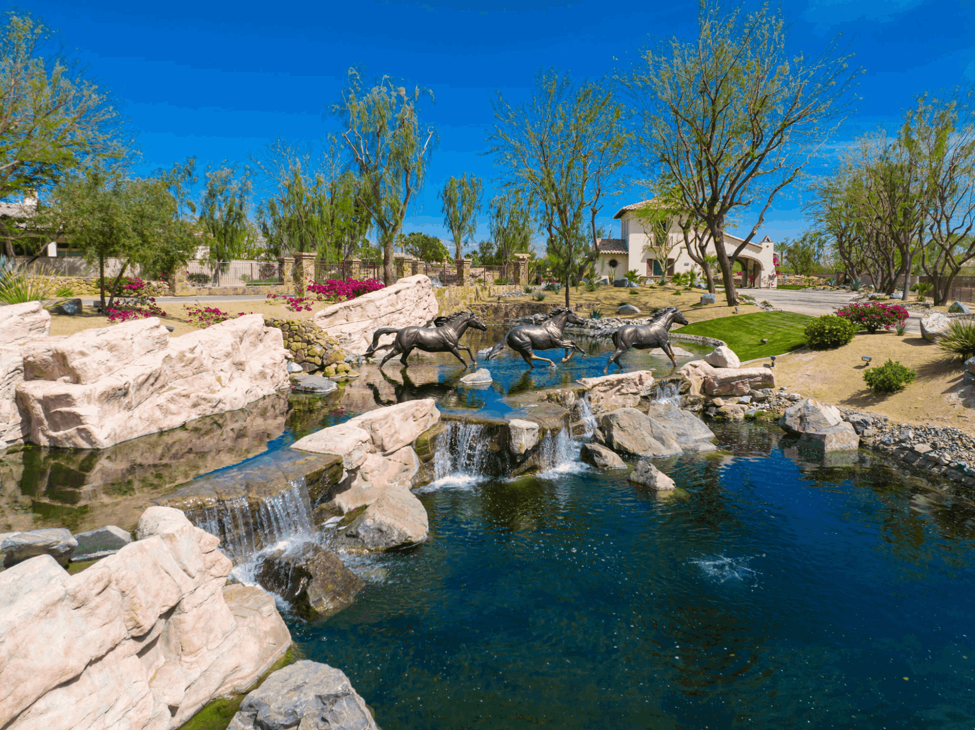 Equestrian-inspired horse sculpture and water feature surrounded by desert landscaping at Griffin Ranch in La Quinta