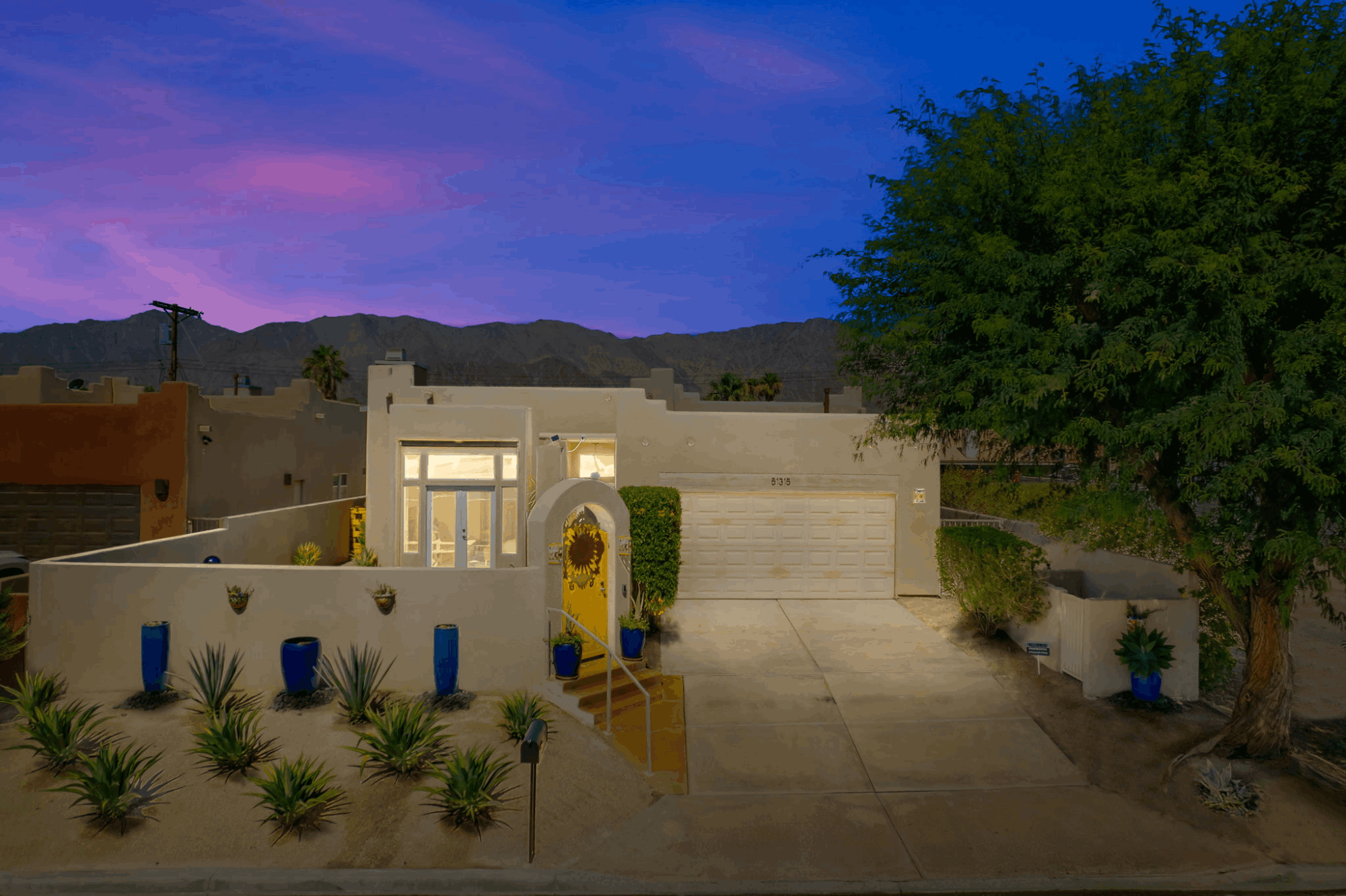 Santa Fe-style home at twilight with mountain views in La Quinta Cove