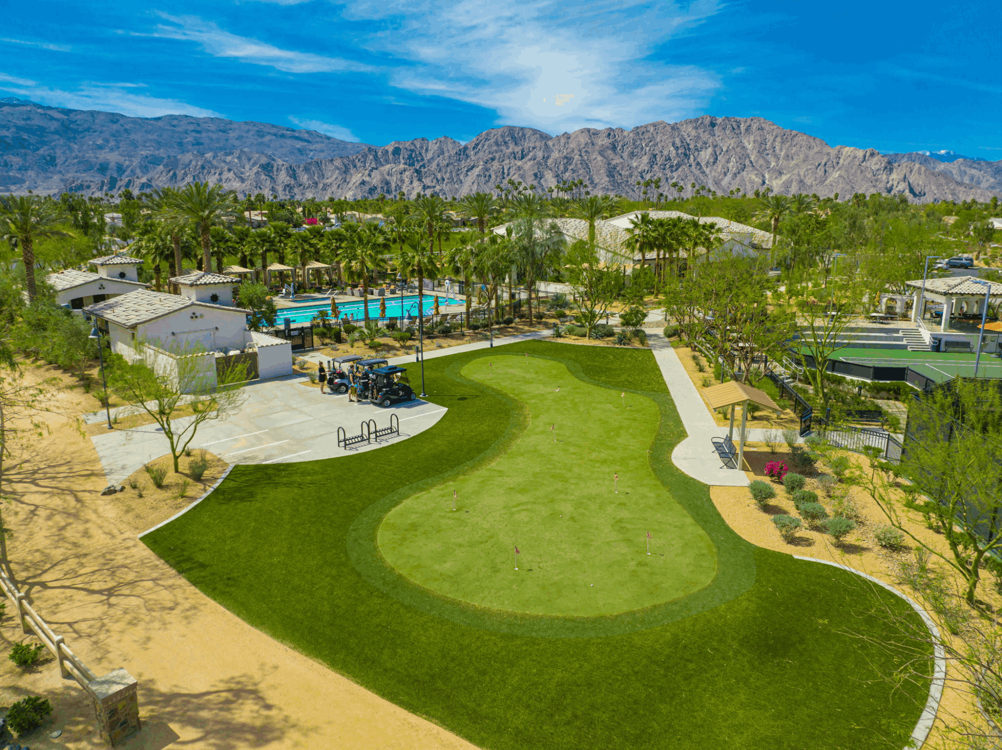 Aerial view of the putting green, pool, courts and clubhouse amenities at Griffin Ranch in La Quinta