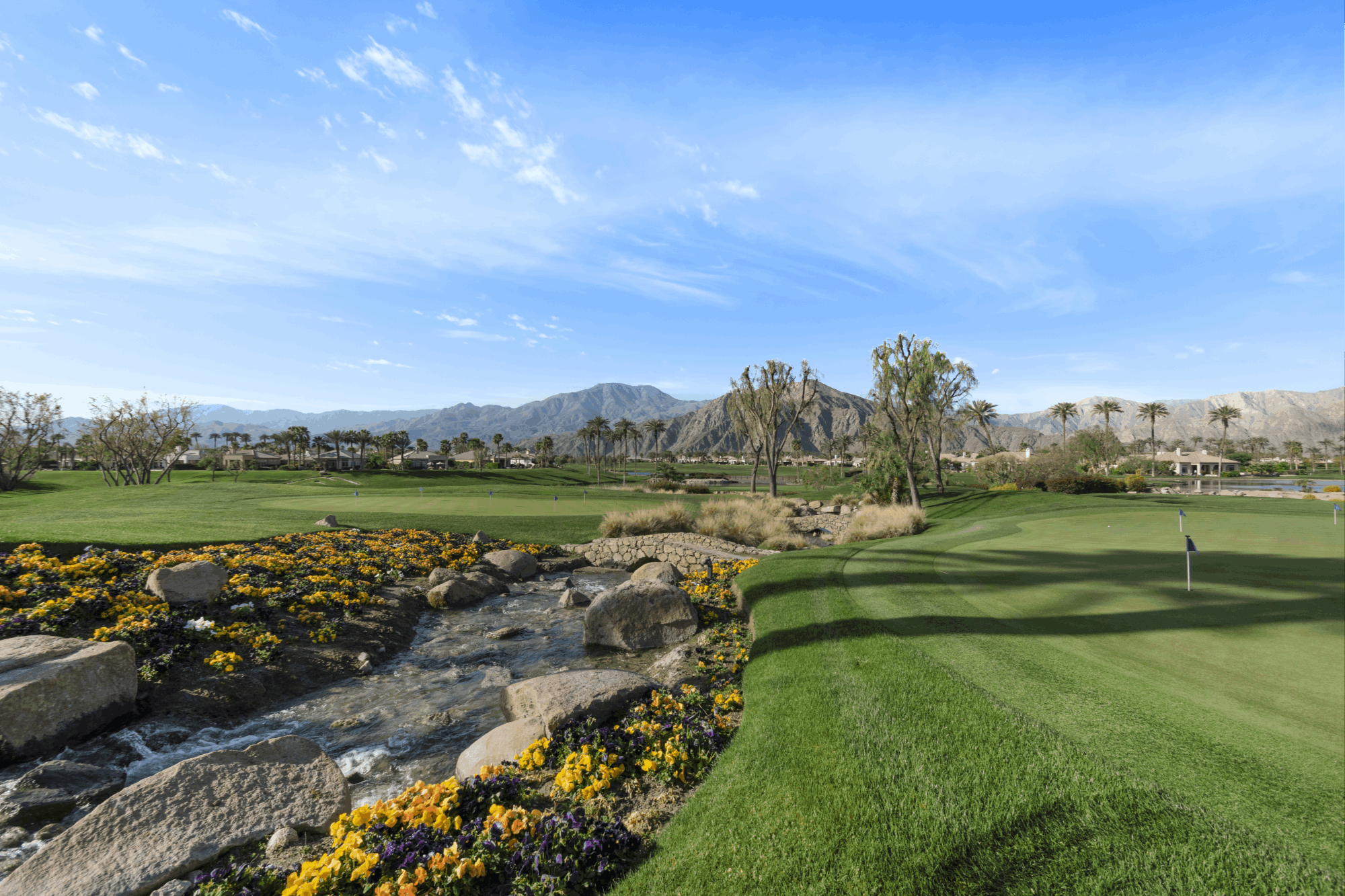 Golf practice facilities at PGA WEST with water features and Santa Rosa Mountain views