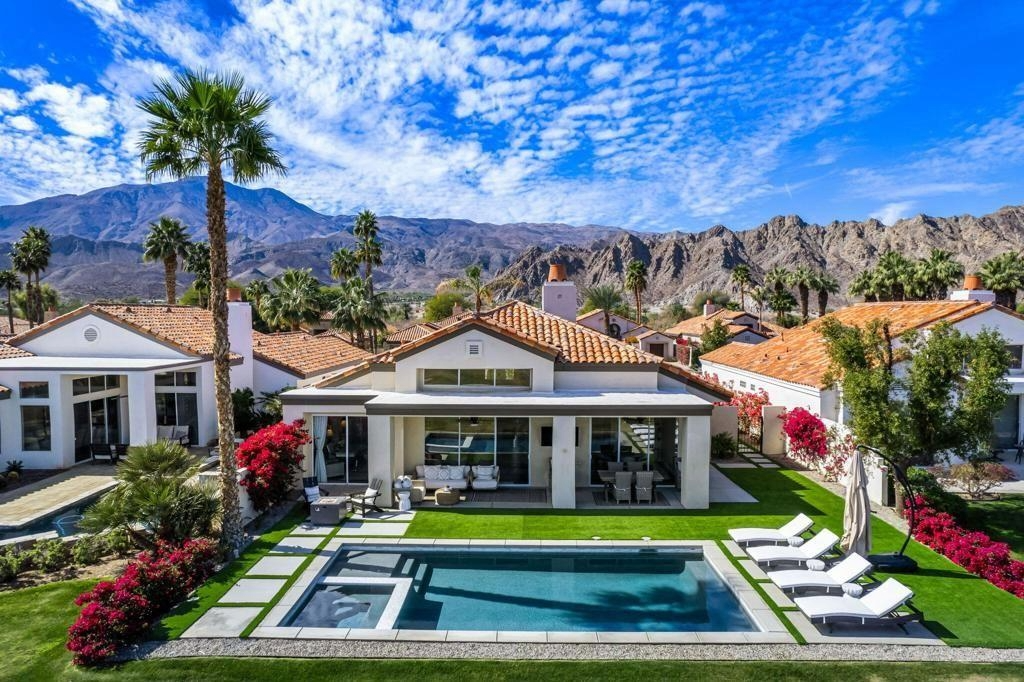 Aerial view of PGA WEST homes beside golf courses and lakes in La Quinta, California