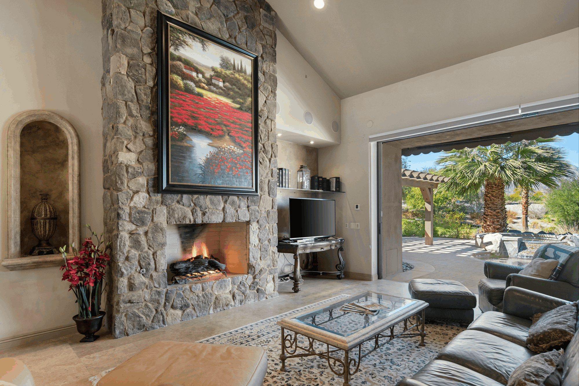 PGA WEST home interior with stone fireplace, high ceilings and opening to a private pool