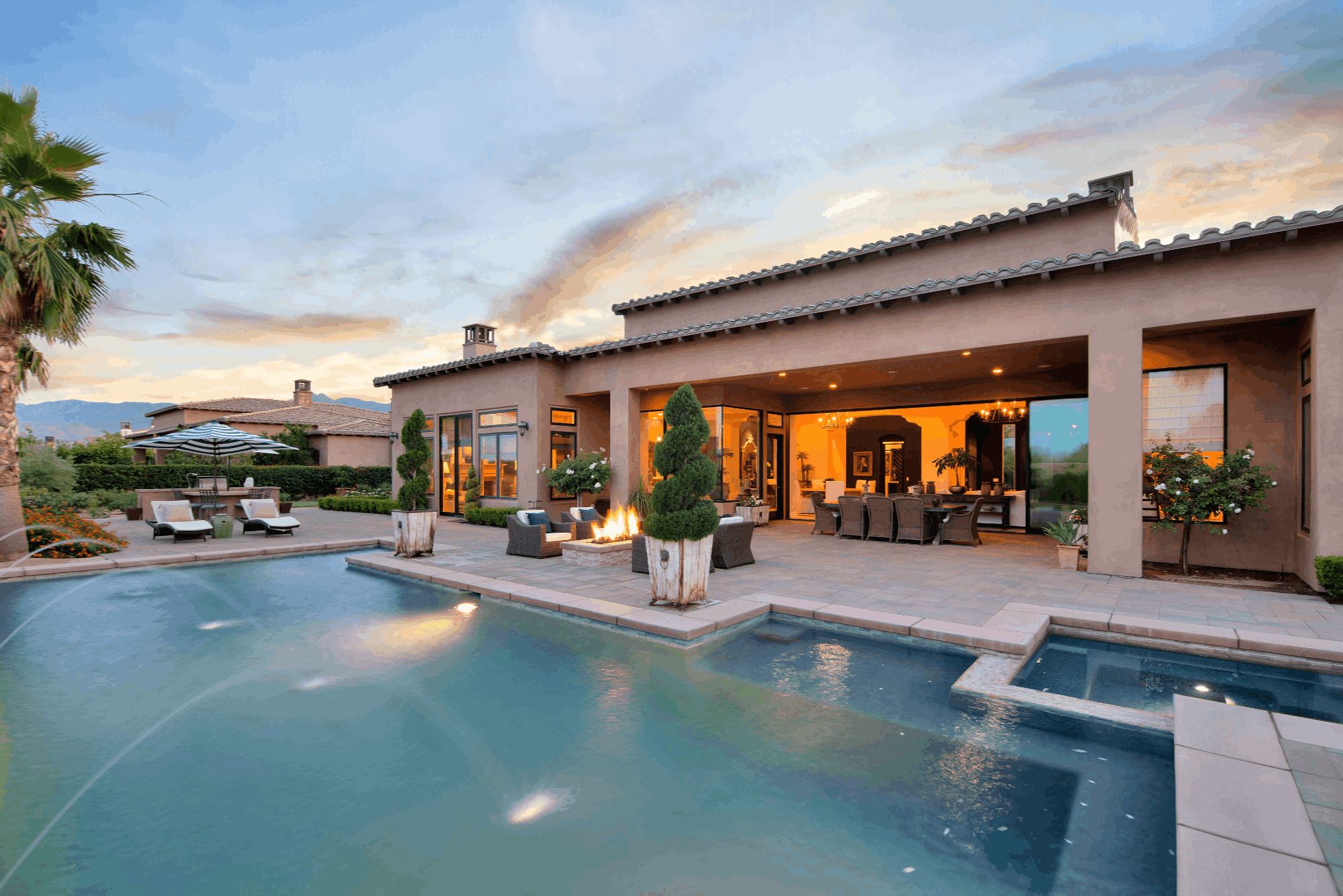 Contemporary PGA WEST home with swimming pool and outdoor living areas at twilight