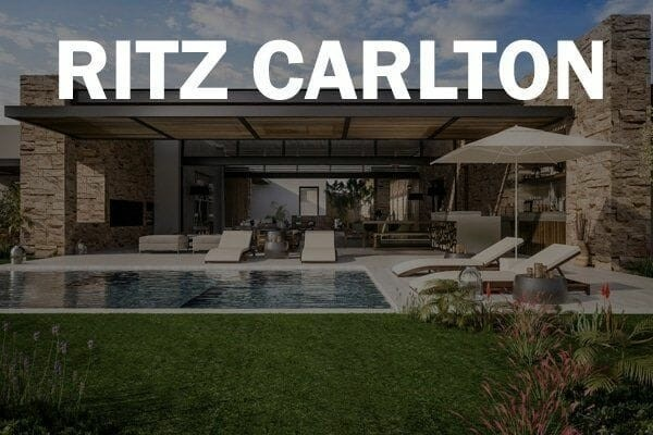 A luxurious property with a pool and lounge chairs