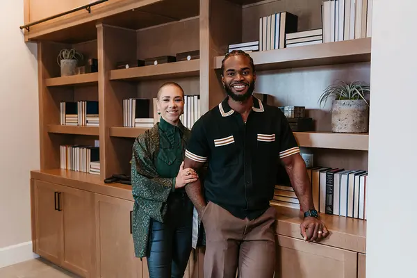 Whitney Myer and Jordan Arroyo, real estate agents at Myer Arroyo Real Estate in Northern Nevada, standing together and smiling in a professional setting.