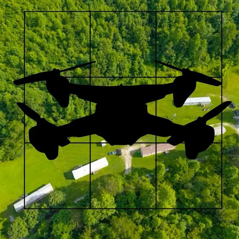 Aerial drone silhouette overlay on grid view of rural Kentucky homes and green forest, highlighting drone photography services for real estate with Williams Elite Realty.