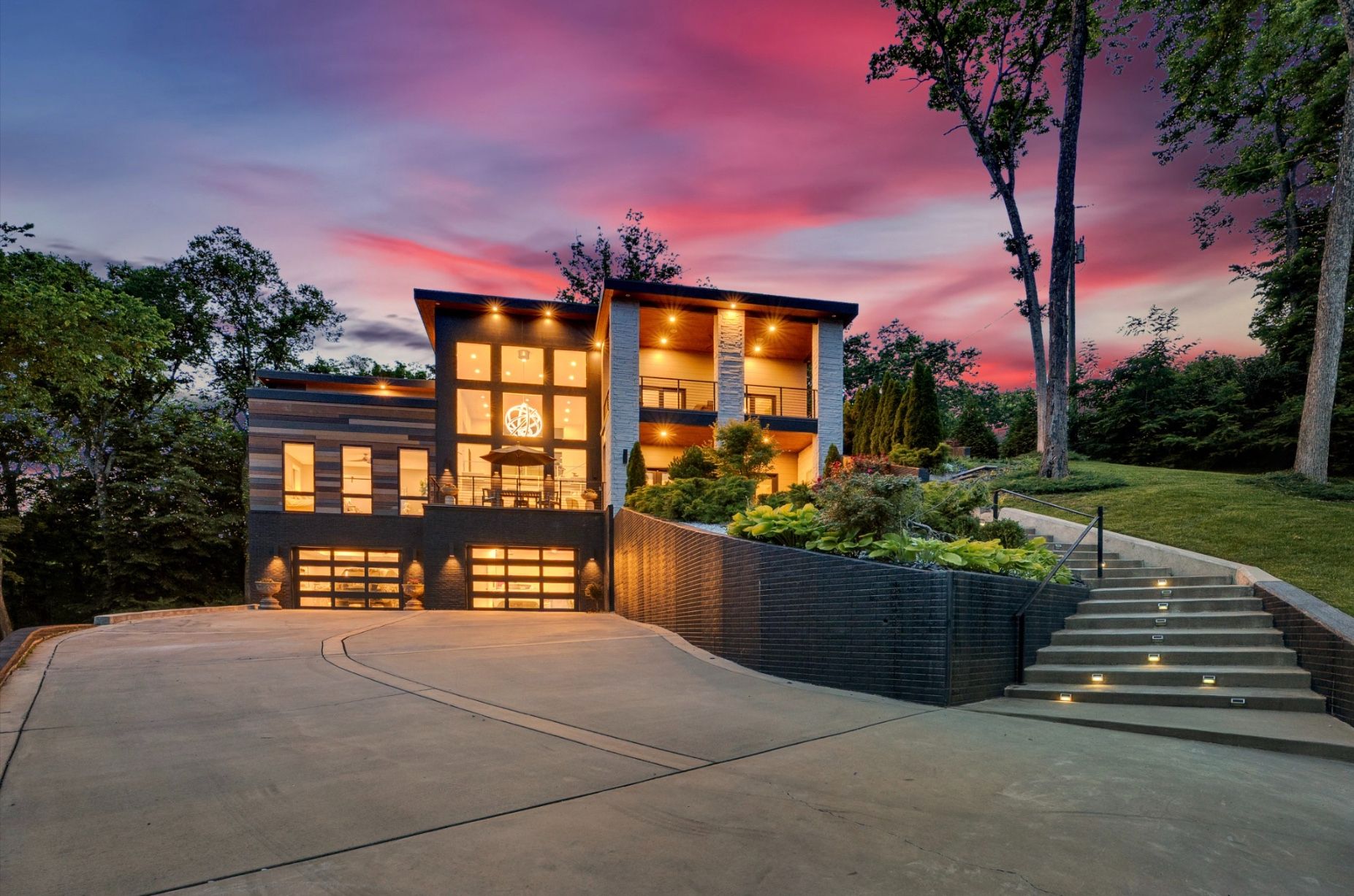 Modern home at twilight with every window lit, 6616 Ellwood Court, Nashville
