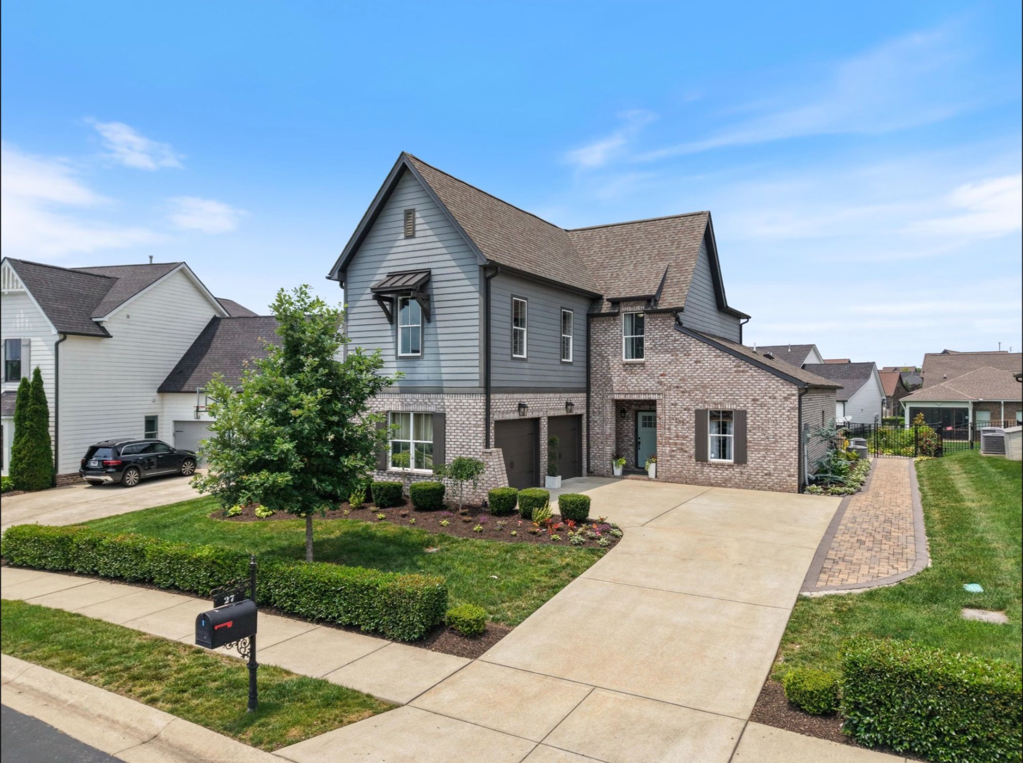Two-story craftsman home with a landscaped front yard