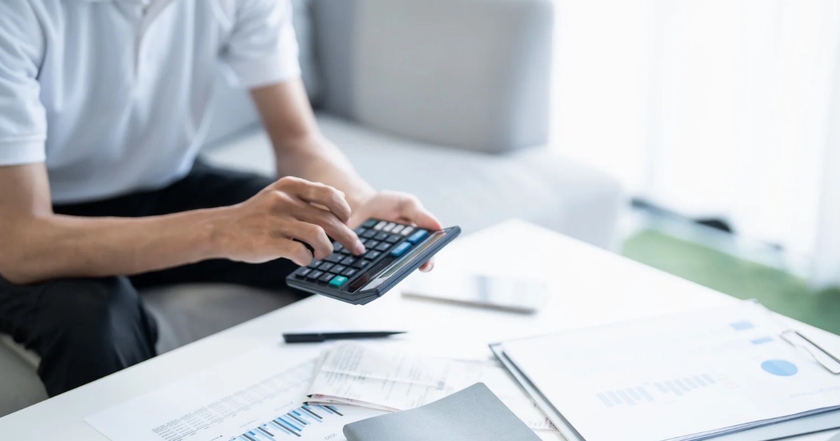 Mortgage paperwork, calculator, and home purchase budget arranged on a desk for Central Ohio move-up planning