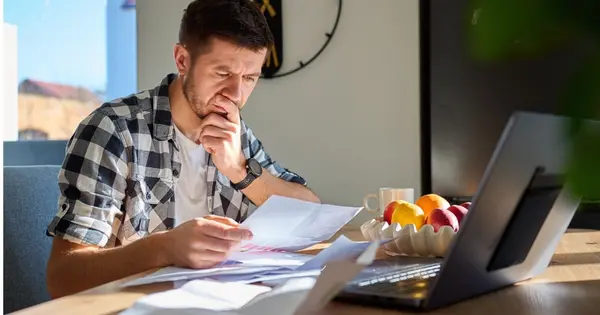 organized paperwork on a table with a notebook, laptop or calculator