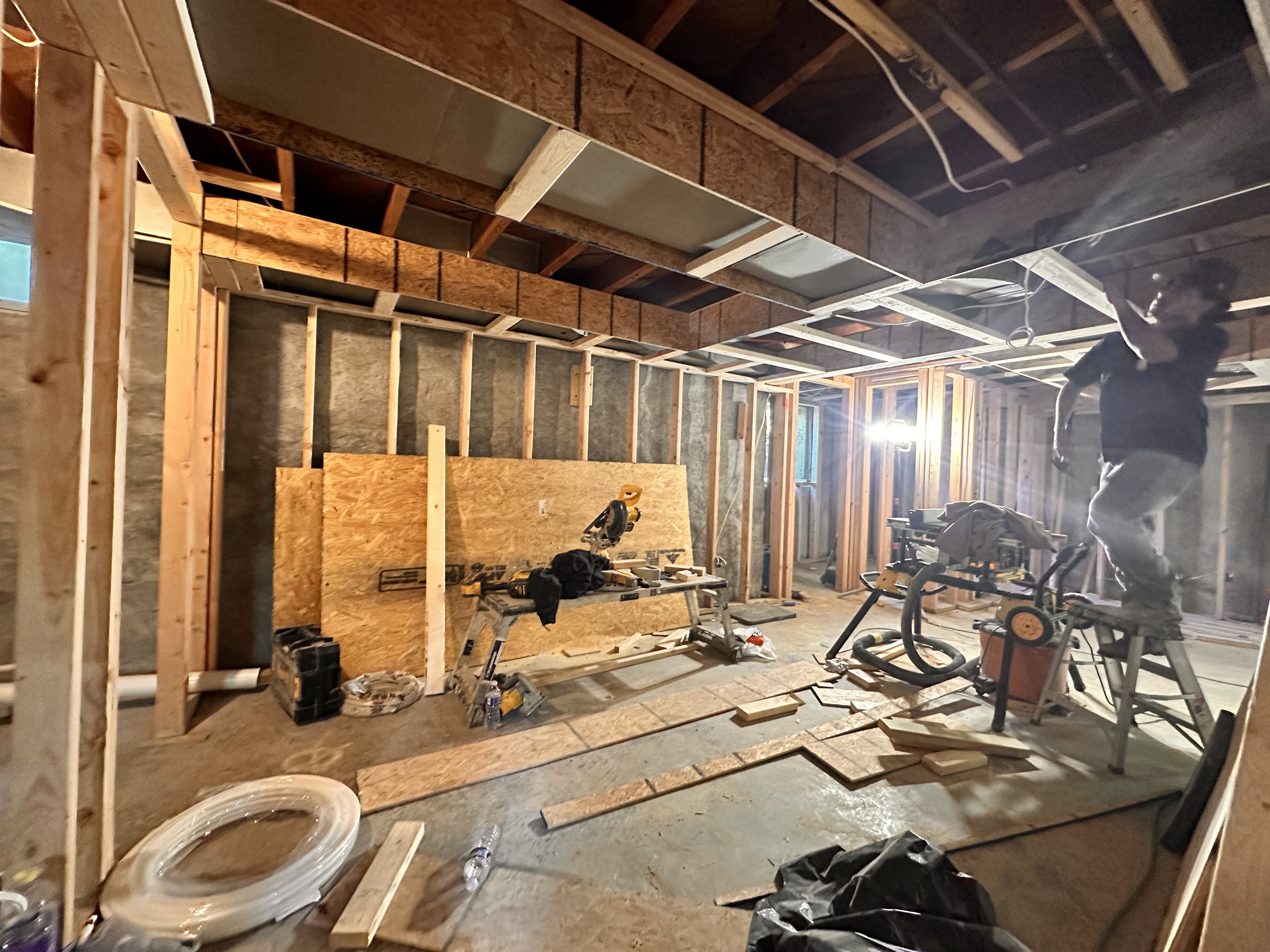 The family room where the hvac runs were being planned and installed, looking toward the new bathroom and closet in the basement.