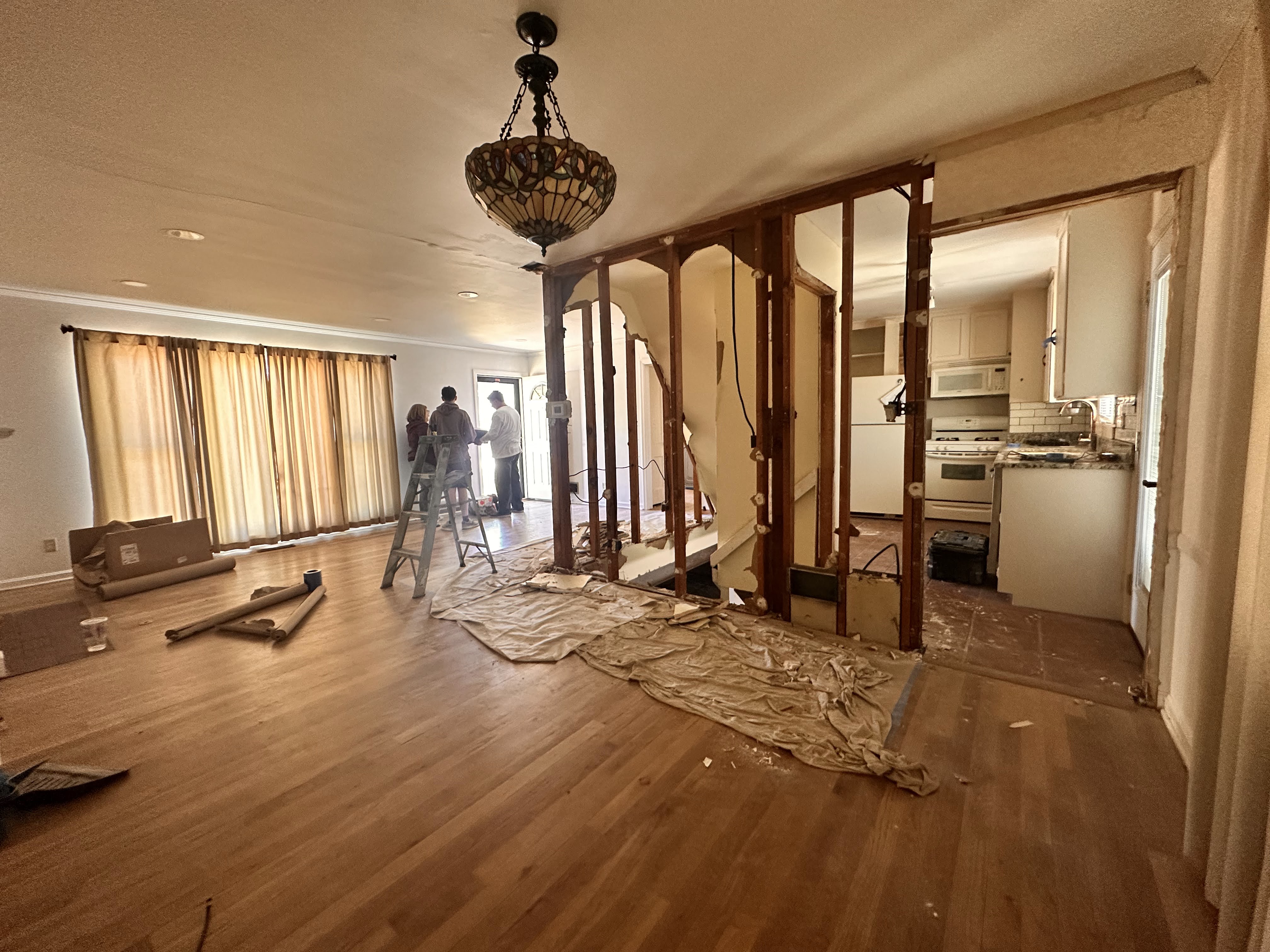 Looking from the dining room toward the front door showing the massive, ill-placed staircase that we were planning to relocate.