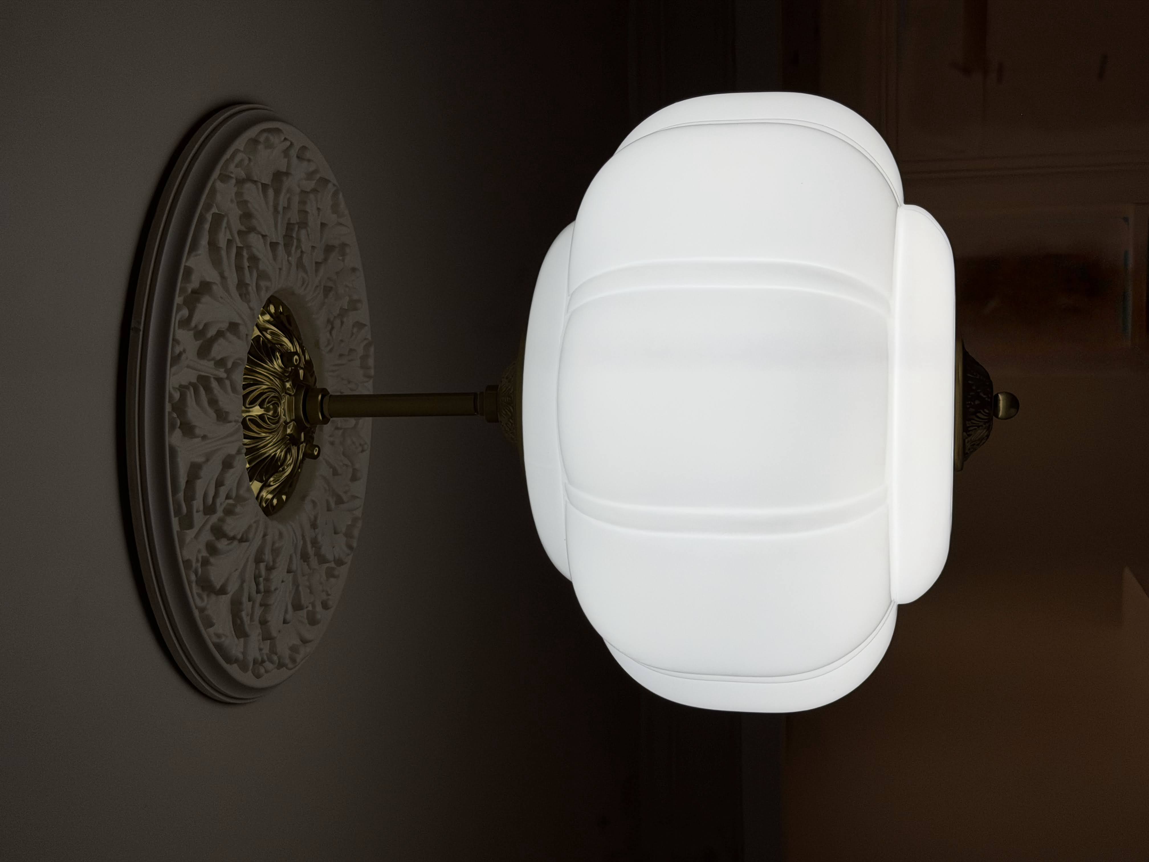 The gorgeous milk glass lighting underpinned by vintage ceiling medallions.