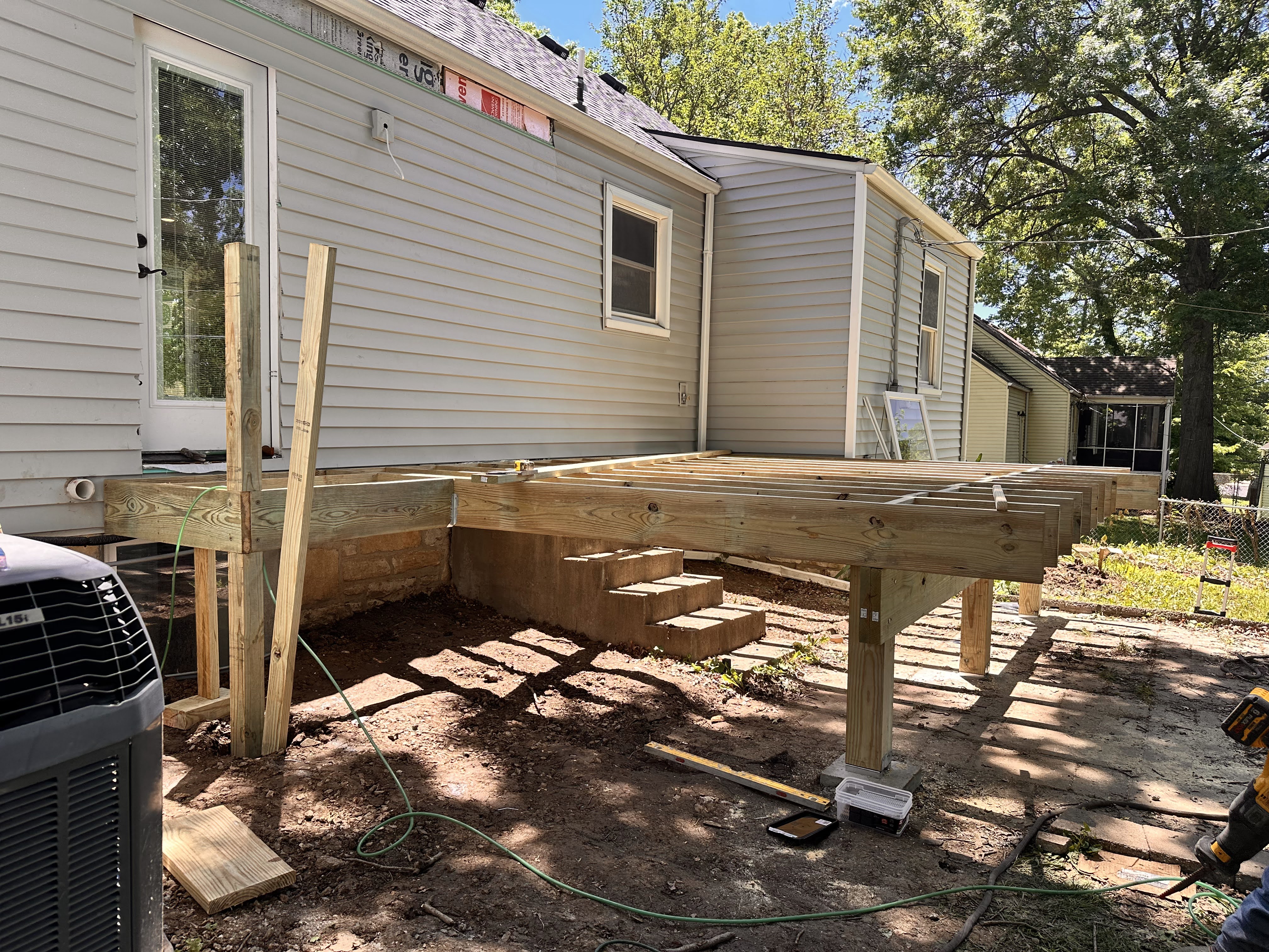 The new deck being built off of the back door that was moved over about 6'.