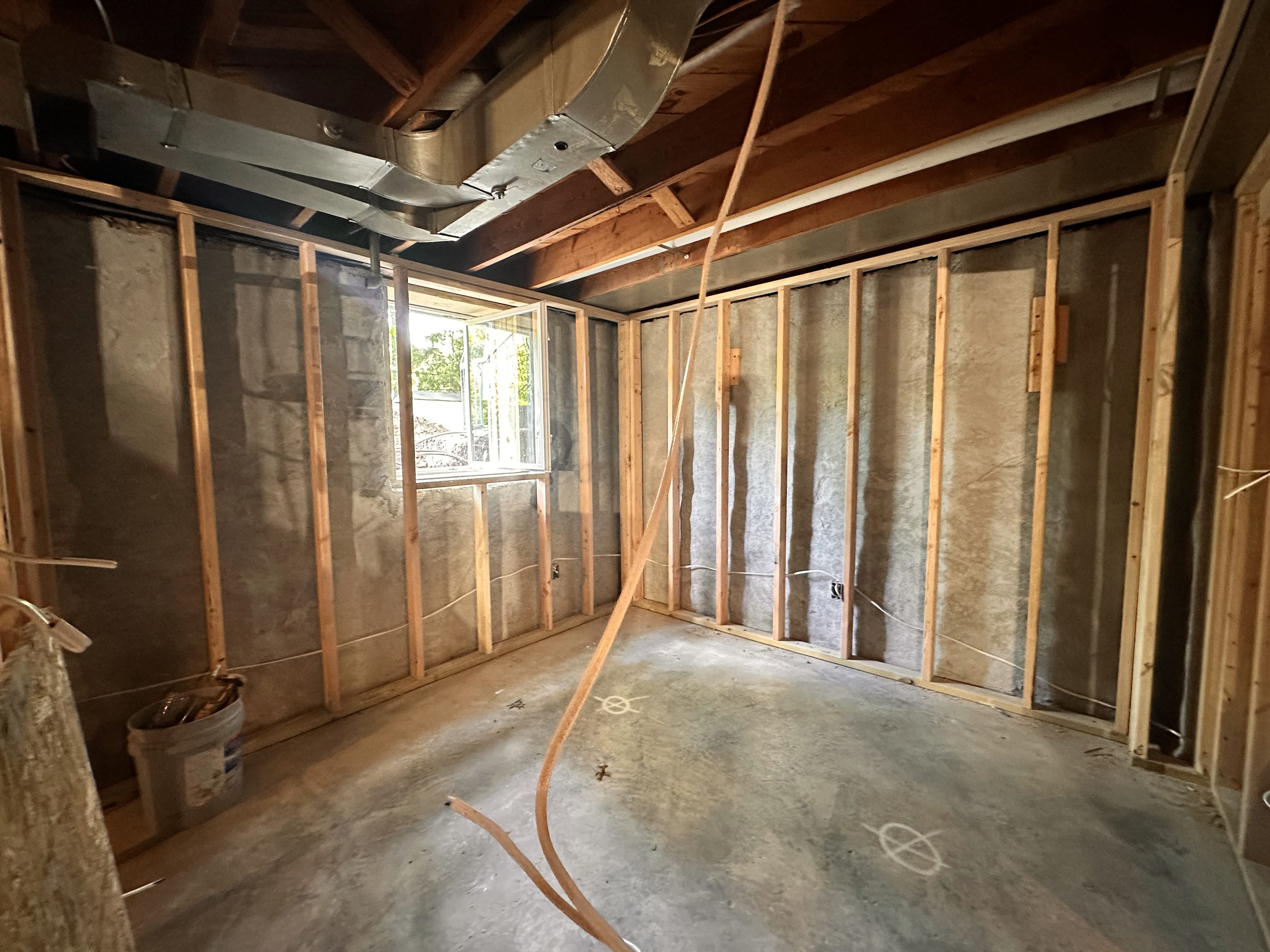Framing out the third bedroom showing the newly installed egress windows