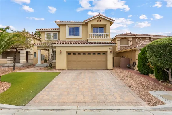 2 story paver drive way green grass palm tree 2 car garage