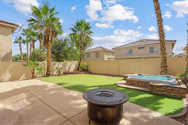 back yard green turf 8 seat spa fire pit palm trees cool decking patio