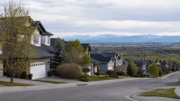 Residential street in an established Calgary neighbourhood with the foothills on the horizon