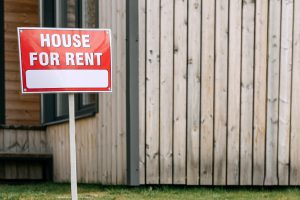 Renting image with a 'House for Rent' sign background