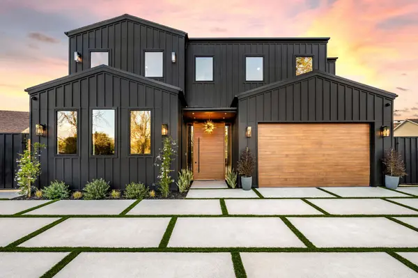 modern-black-house-with-wooden-garage-door-at-suns-2025-02-10-06-40-46-utc