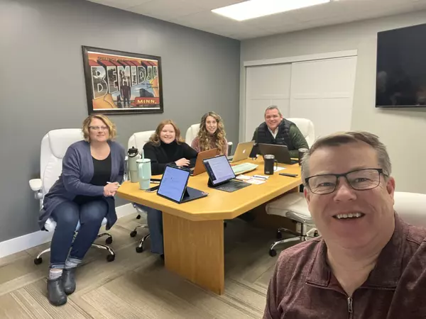 Melissa Hoover, Sydney South, Becky Johnson, Zach Miller and Doug Hoover at office meeting in the Bemidji Real Broker office. 