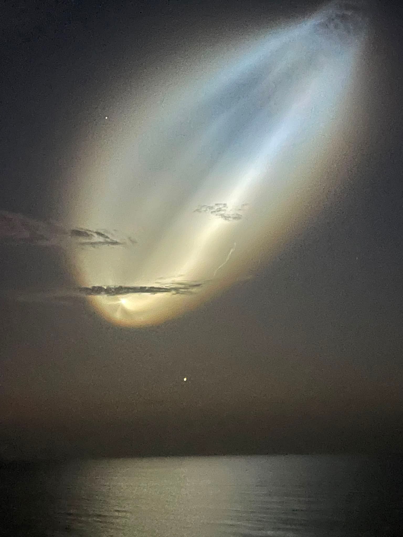 SpaceX rocket launch forming a space jellyfish light over Daytona Beach coast