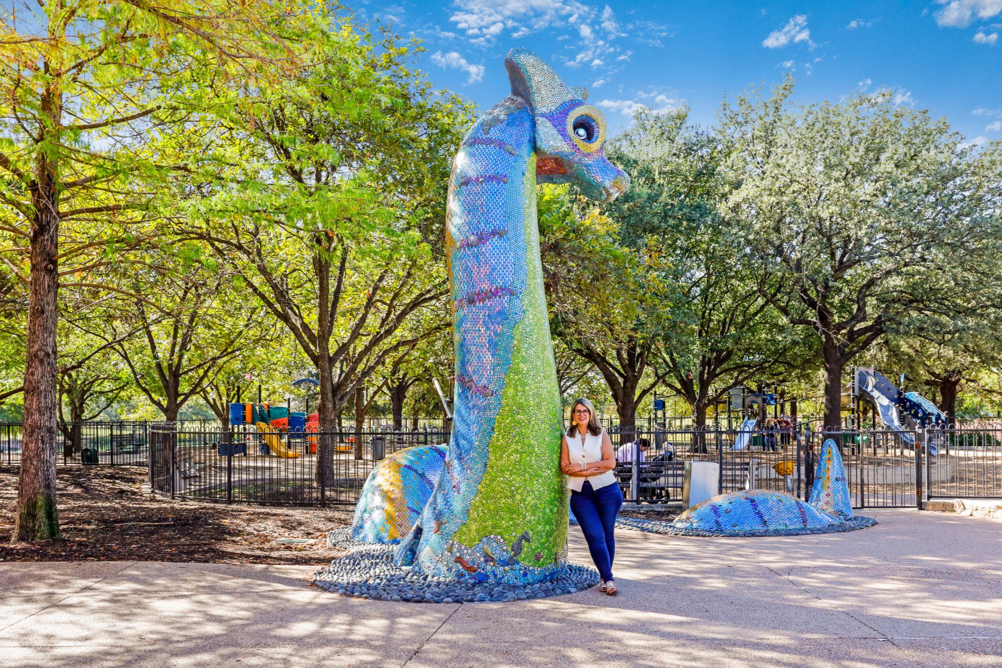 Frances Kelley Ozaki, real estate agent, leaning against Nessy at Mueller Lake Park