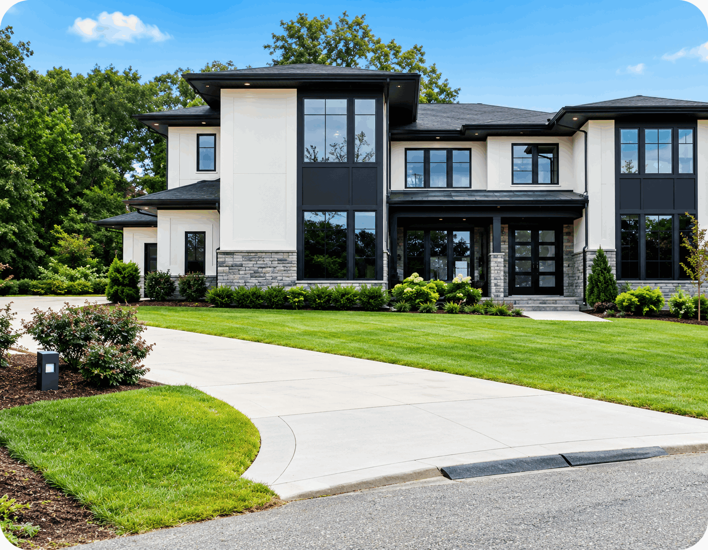 Modern two-story home with a manicured front lawn in a wooded neighborhood