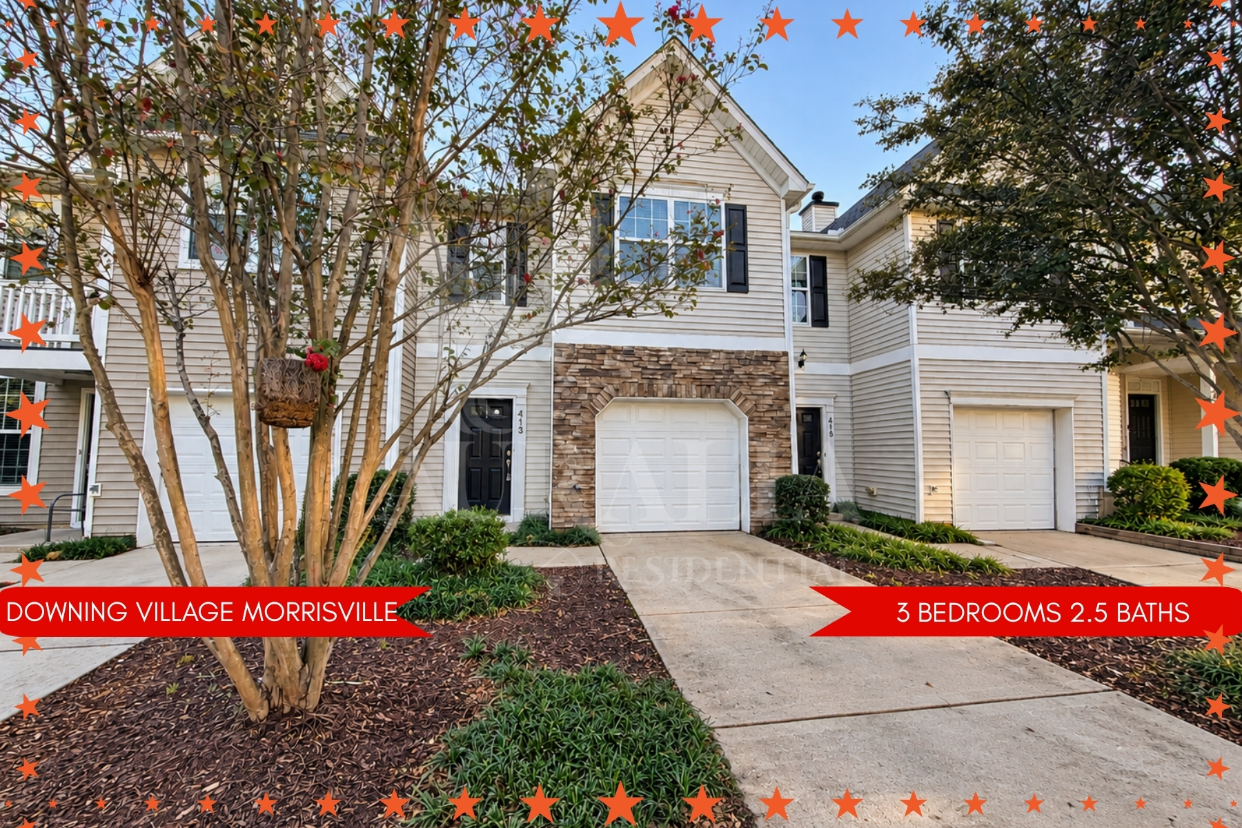 Two-story townhome at 413 Plank Bridge Way in Downing Village, Morrisville NC, with a stone-front attached garage