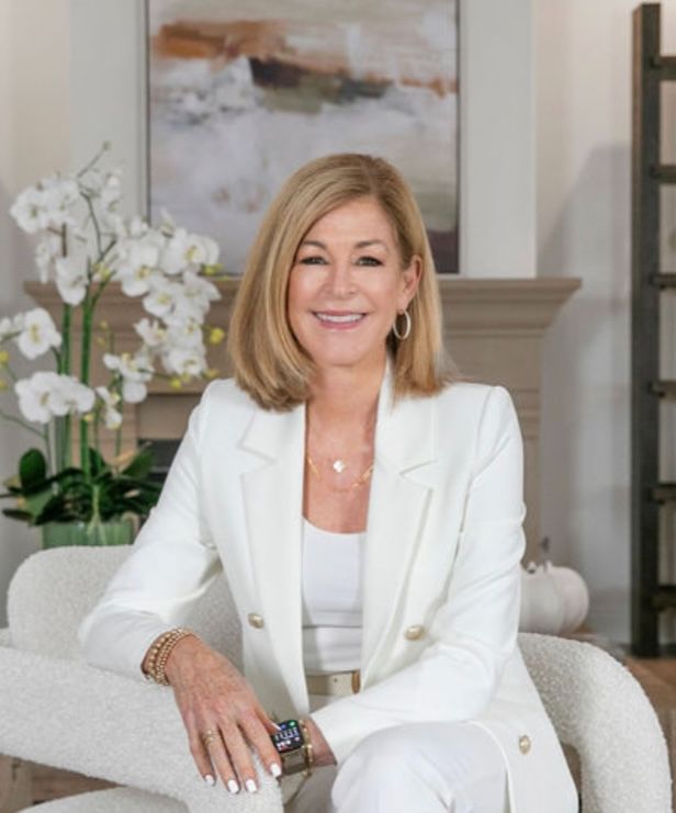 Professional portrait of Susan Chase, a Top 1.5% real estate agent in Dana Point and 30-year local resident, smiling in a professional setting.