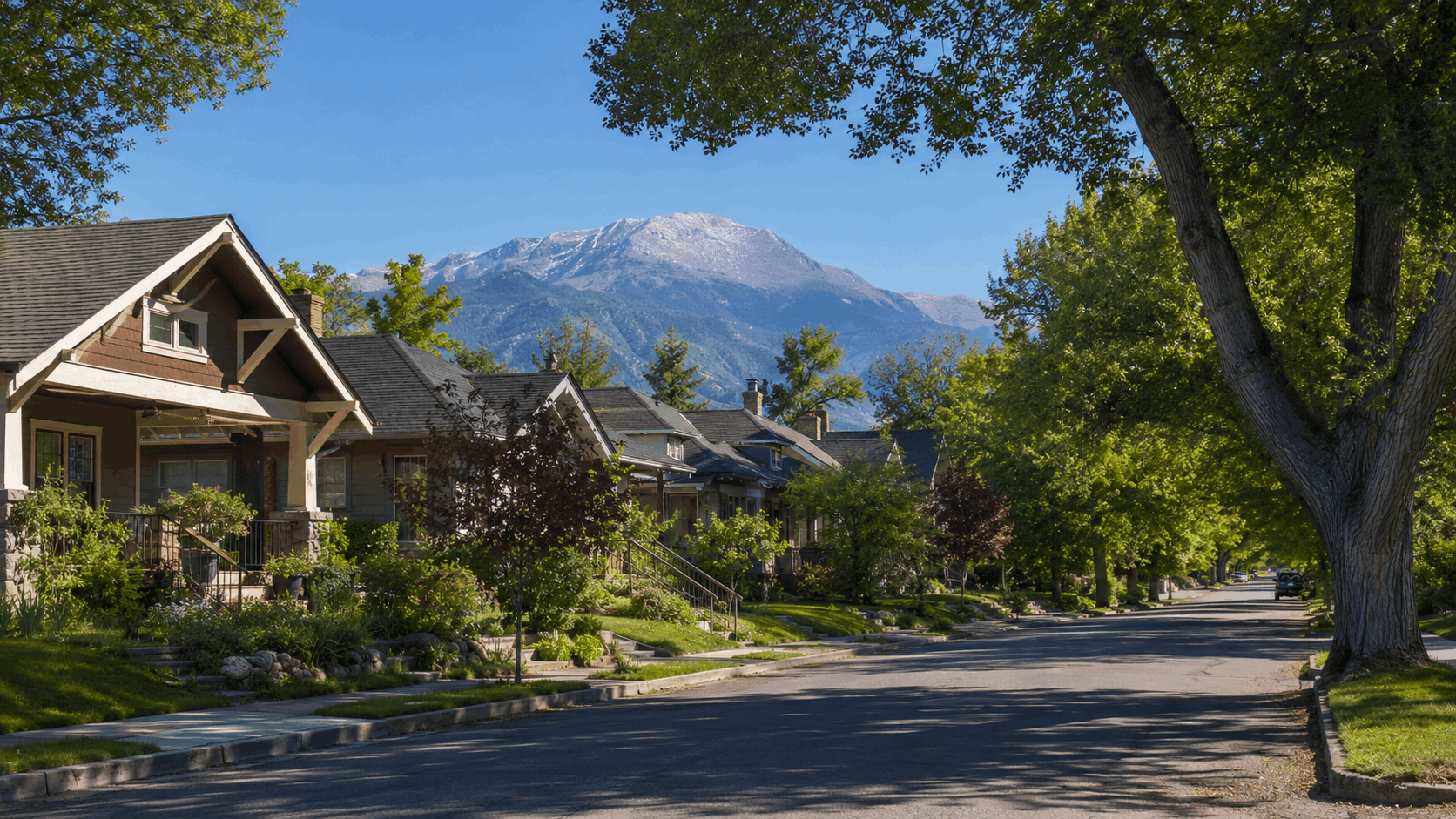 "Tree-lined street in Ivywild neighborhood Colorado Springs with craftsman bungalows and Pikes Peak views"