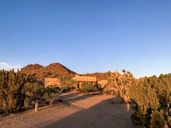Image of Santa Fe style home in lush desert setting